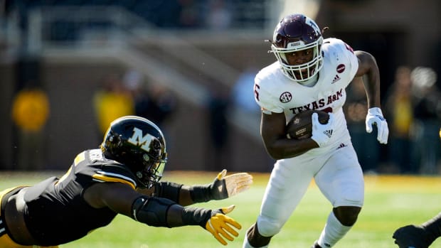 Oct 16, 2021; Columbia, Missouri, USA; Texas A&M Aggies running back Devon Achane (6) runs against Missouri Tigers defensive lineman Darius Robinson (6) during the second half at Faurot Field at Memorial Stadium.